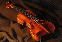 violin on red fabric