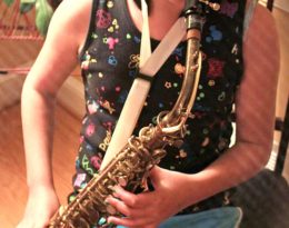 girl playing vintage king zephyr saxophone